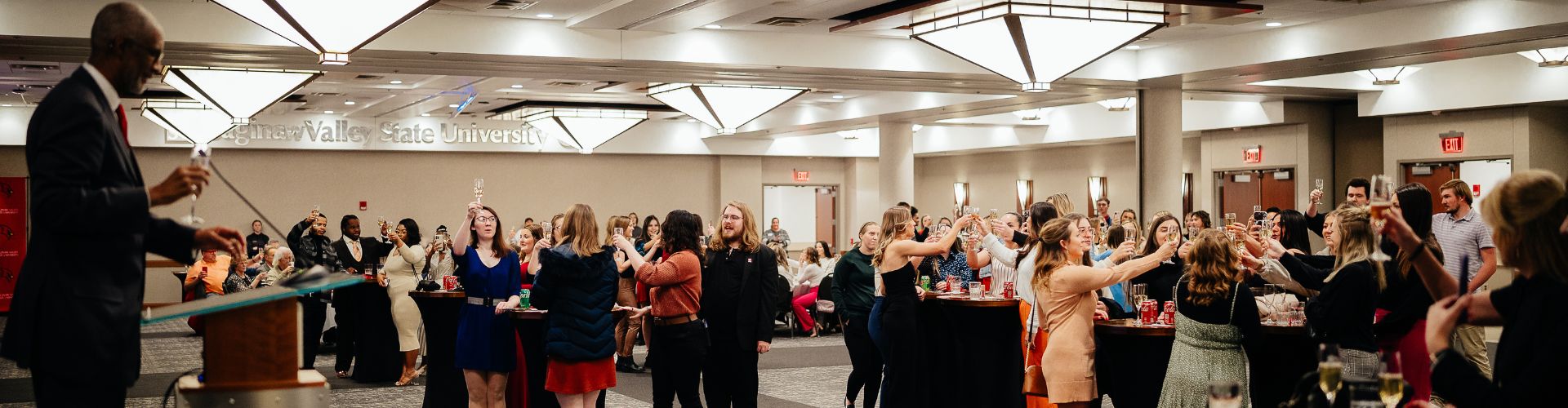 crowd raising champagne classes